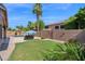 Expansive backyard showcasing a pool, manicured lawn, and privacy landscaping creating a serene outdoor oasis at 1144 E Nunneley Rd, Gilbert, AZ 85296