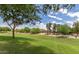 Sprawling green backyard with mature trees in a well-maintained community at 1144 E Nunneley Rd, Gilbert, AZ 85296
