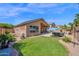 Lush green backyard featuring a well-maintained lawn, patio, and landscaping for outdoor enjoyment at 1144 E Nunneley Rd, Gilbert, AZ 85296