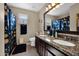 Bright bathroom featuring dual sinks, granite countertop and a decorative mirror at 1144 E Nunneley Rd, Gilbert, AZ 85296