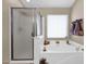 Detailed view of the soaking tub and shower area with neutral tones and tiled walls at 1144 E Nunneley Rd, Gilbert, AZ 85296