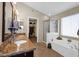 Luxurious bathroom featuring double sinks, granite countertops, a soaking tub, and a walk-in shower at 1144 E Nunneley Rd, Gilbert, AZ 85296