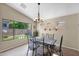 Bright dining room with large windows offering views of the landscaped backyard at 1144 E Nunneley Rd, Gilbert, AZ 85296