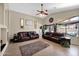 Open living room with tile flooring, ceiling fan, and large windows with backyard views at 1144 E Nunneley Rd, Gilbert, AZ 85296