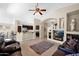 Bright and airy living room with an open floor plan, tile floors, and custom built-in shelving at 1144 E Nunneley Rd, Gilbert, AZ 85296
