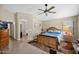 Comfortable main bedroom with a cozy atmosphere, ceiling fan, and tiled floors at 1144 E Nunneley Rd, Gilbert, AZ 85296