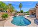 Sparkling pool features rock waterfall, lush landscaping, and ample seating for relaxing in the sun at 1144 E Nunneley Rd, Gilbert, AZ 85296