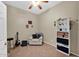 Versatile spare room with a ceiling fan, chair, and shelving unit at 1144 E Nunneley Rd, Gilbert, AZ 85296