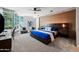 Serene bedroom featuring textured accent wall, a king-size bed, and large windows that offer natural light at 120 E Rio Salado E Pkwy # 102, Tempe, AZ 85281