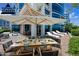 Staged patio featuring an umbrella-covered dining table and outdoor lounge chairs at 120 E Rio Salado E Pkwy # 102, Tempe, AZ 85281