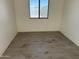Clean bedroom featuring a large window and tile floors at 121 N Brown Ave, Casa Grande, AZ 85122