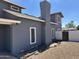 Side view of a two-story home showing the chimney and fenced yard at 121 N Brown Ave, Casa Grande, AZ 85122