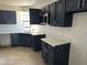 Kitchen with dark cabinets, light countertops, and tile flooring at 121 N Brown Ave, Casa Grande, AZ 85122
