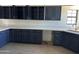 Spacious kitchen with dark cabinets and light countertops, plus a sink under the window at 121 N Brown Ave, Casa Grande, AZ 85122