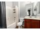Cozy bathroom with a combined bathtub and shower featuring white tile, paired with a cherry-wood vanity at 121 N California St # 35, Chandler, AZ 85225