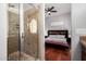 Beautiful bathroom with glass-enclosed shower and a glimpse into an adjacent stylish bedroom at 121 N California St # 35, Chandler, AZ 85225