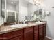 Elegant bathroom features double sinks, granite countertops, and a view of the glass-enclosed shower at 121 N California St # 35, Chandler, AZ 85225