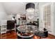Open-concept dining area featuring a glass table, modern chandelier, and access to the living spaces at 121 N California St # 35, Chandler, AZ 85225