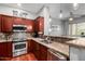 Modern kitchen featuring granite countertops, stainless steel appliances, and dark wood cabinets at 121 N California St # 35, Chandler, AZ 85225