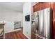Modern stainless steel refrigerator in a kitchen area adjacent to an upper level hallway with railing at 121 N California St # 35, Chandler, AZ 85225