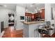 View of the kitchen with stainless steel appliances and dark wood cabinets; bedroom in background at 121 N California St # 35, Chandler, AZ 85225