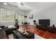 Cozy living room featuring hardwood floors, natural lighting, and an entertainment area with a large-screen TV at 121 N California St # 35, Chandler, AZ 85225