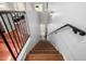 Inviting staircase features wood and carpeted steps, metal railing, and sconce lighting at 121 N California St # 35, Chandler, AZ 85225