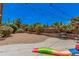 A spacious backyard with gravel, a concrete patio, string lights, and lovely, mature landscaping at 1282 N Banning St, Gilbert, AZ 85234