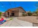 View of the backyard, showing the patio and landscaping against the home's exterior under a sunny sky at 1282 N Banning St, Gilbert, AZ 85234