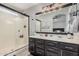 Bathroom features dual sinks, vanity with storage, and a glass enclosed shower at 1282 N Banning St, Gilbert, AZ 85234