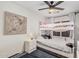 Bright bedroom features a bunk bed, white walls, a ceiling fan, and an abstract piece of artwork at 1282 N Banning St, Gilbert, AZ 85234