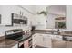 Kitchen with stainless steel appliances, granite countertops, and white cabinetry at 1282 N Banning St, Gilbert, AZ 85234