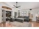 Spacious living room featuring a large sectional sofa, plantation shutters, and modern lighting at 1282 N Banning St, Gilbert, AZ 85234
