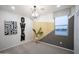 This bedroom features eye-catching wall decor, modern light fixture, and neutral carpet at 13195 N 145Th Ln, Surprise, AZ 85379