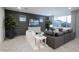 Stylish living room featuring a dark accent wall, chic furniture, and large windows at 13195 N 145Th Ln, Surprise, AZ 85379