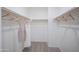 Spacious walk-in closet with ample hanging space and carpet flooring at 13195 N 145Th Ln, Surprise, AZ 85379