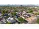 Scenic view of the neighborhood showcasing lush trees, varied rooflines, and distant mountains at 1338 E Granada Rd, Phoenix, AZ 85006
