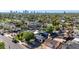 Wide-angle view of a neighborhood with mature trees, nearby city, and a mix of residential homes at 1338 E Granada Rd, Phoenix, AZ 85006
