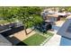 Charming backyard featuring turf, desert landscaping, concrete tile accents, and a detached garage at 1338 E Granada Rd, Phoenix, AZ 85006