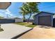 An open backyard with turf, concrete patio, and a converted garage set against a serene sky at 1338 E Granada Rd, Phoenix, AZ 85006