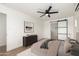 Serene bedroom with a sliding barn door to the bathroom, modern ceiling fan, and stylish decor at 1338 E Granada Rd, Phoenix, AZ 85006