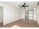 Bright bedroom featuring luxury vinyl plank flooring, modern ceiling fan, and new sliding barn door at 1338 E Granada Rd, Phoenix, AZ 85006