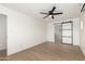 Open bedroom with wood floors and large sliding barn door to ensuite bathroom, and mini split AC at 1338 E Granada Rd, Phoenix, AZ 85006