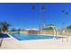 Expansive community pool with tall palm trees and various water features for recreation at 1338 E Granada Rd, Phoenix, AZ 85006