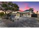 Charming single-story home with a brick driveway, desert landscaping, and a mature shade tree at 1338 E Granada Rd, Phoenix, AZ 85006