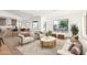 Bright living room showcasing contemporary furnishings, a large window, and an open layout connecting to the updated kitchen at 1338 E Granada Rd, Phoenix, AZ 85006