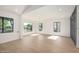 Bright living room featuring light wood floors, recessed lighting, and large windows at 1338 E Granada Rd, Phoenix, AZ 85006