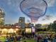 A crowd gathers at dusk for an outdoor cinema event in a downtown park location at 1338 E Granada Rd, Phoenix, AZ 85006