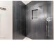 Modern shower featuring dark tile, built-in niche, and chrome fixtures at 1338 E Granada Rd, Phoenix, AZ 85006