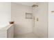 Walk-in shower with mosaic tile flooring, built-in shower niche and gold water fixtures at 1338 E Granada Rd, Phoenix, AZ 85006